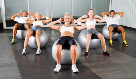 people-in-gym-working-on-exercise-balls